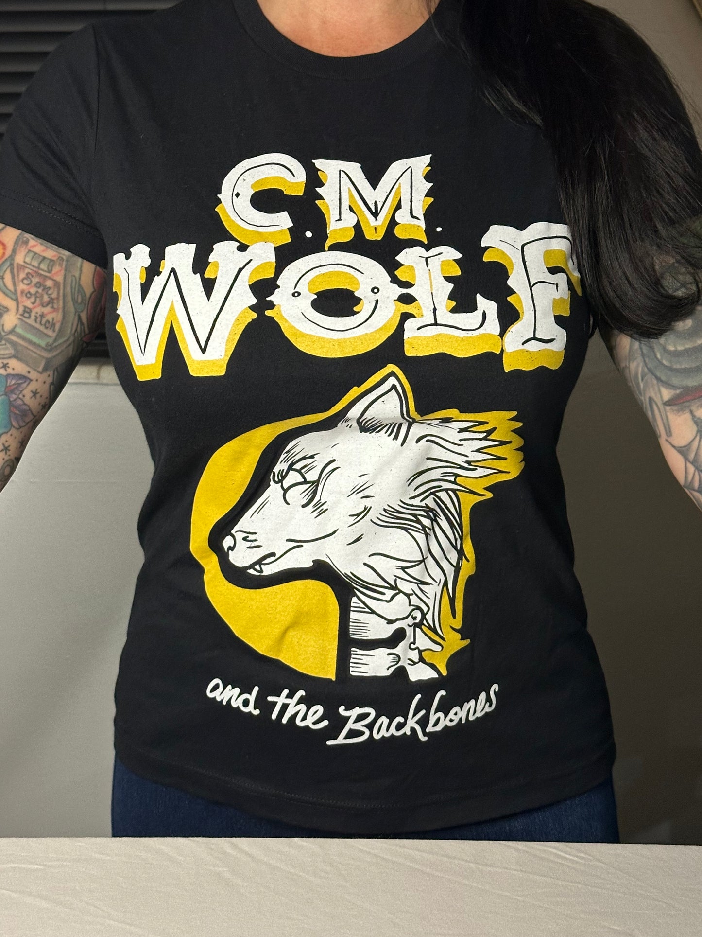 Woman's yellow CM Wolf and The Backbones